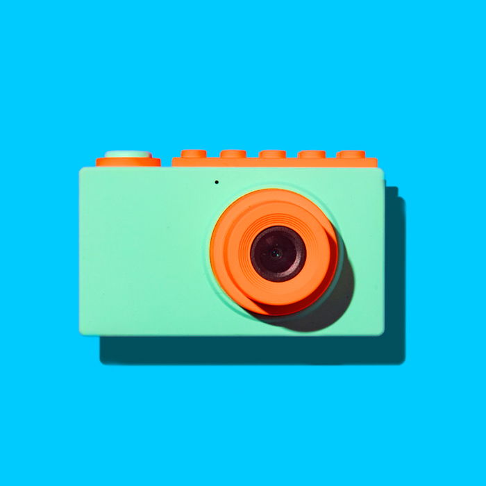 Orange and Seafoam green camera against a blue background