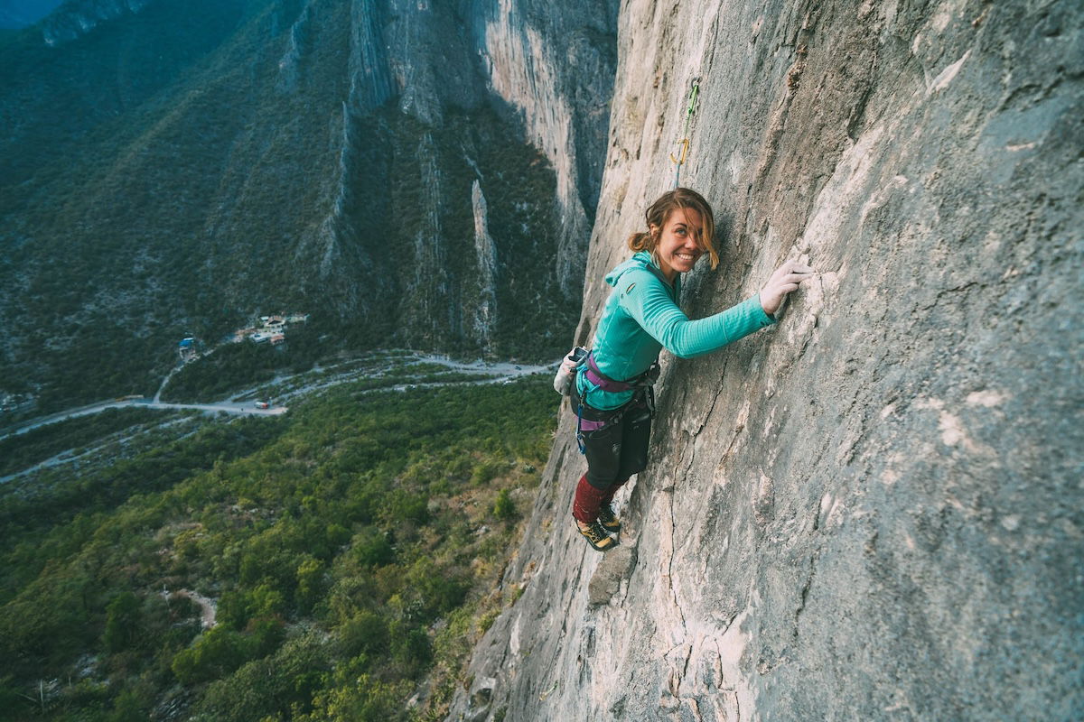 A rock climber on the side of a rock face taken by one of the best sports photographers Savannah Cummins