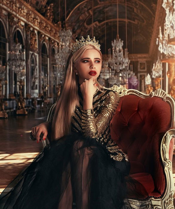 fantasy photograph of a queen posed on a throne in a grand hall