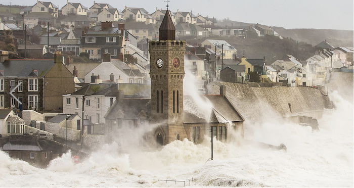 storm waves crash near an old city- landscape photography