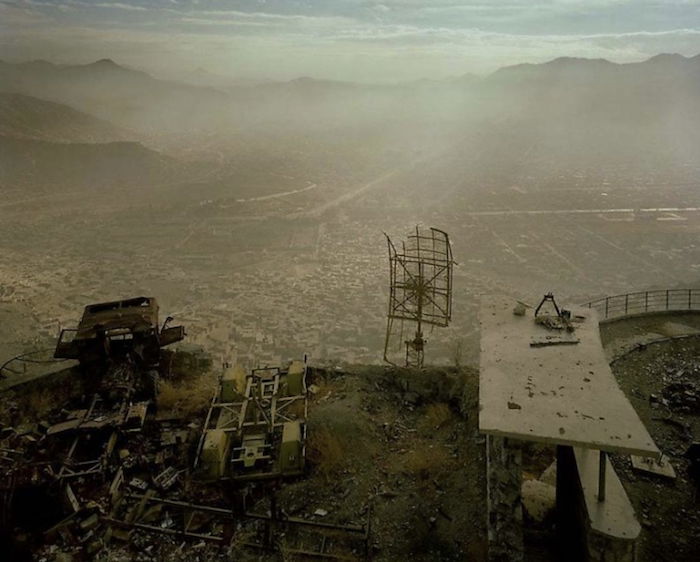 a decrepit satellite dish in an abandoned industrial setting 