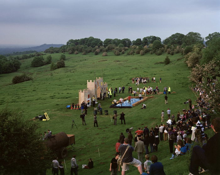 photo of a group gathering on a green grassy field 