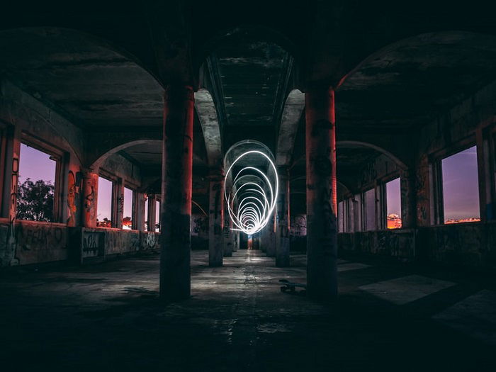 spiral light painting at golden hour under a concrete bridge