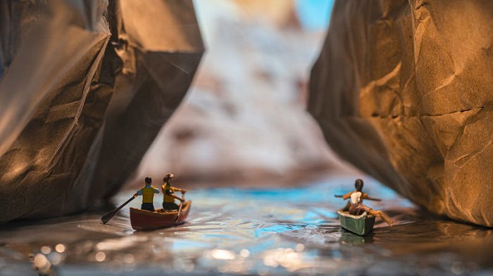 miniature photography of two couples in canoes