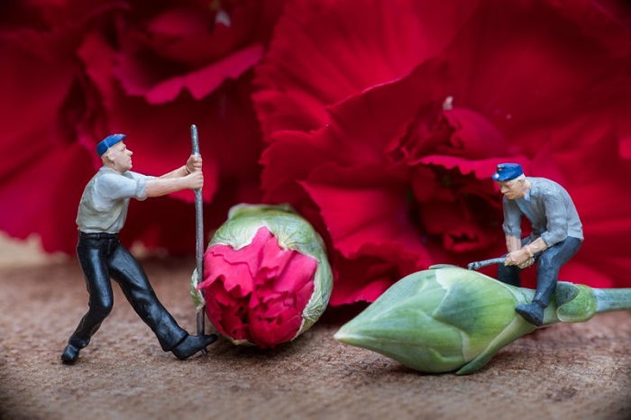 miniature photography of two workers