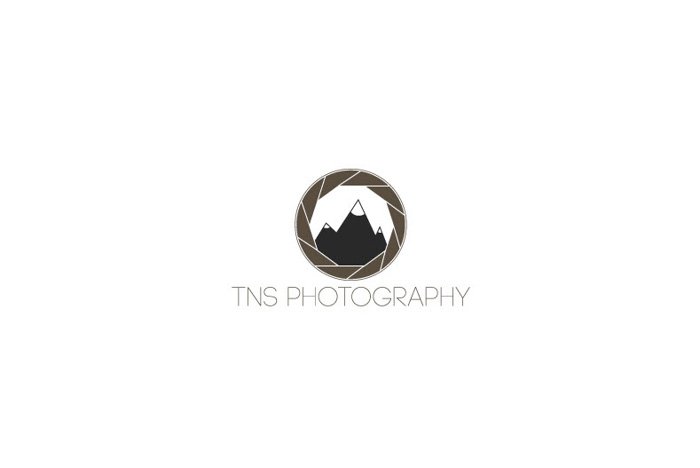 TNS Photography logo using an image of a lens aperture