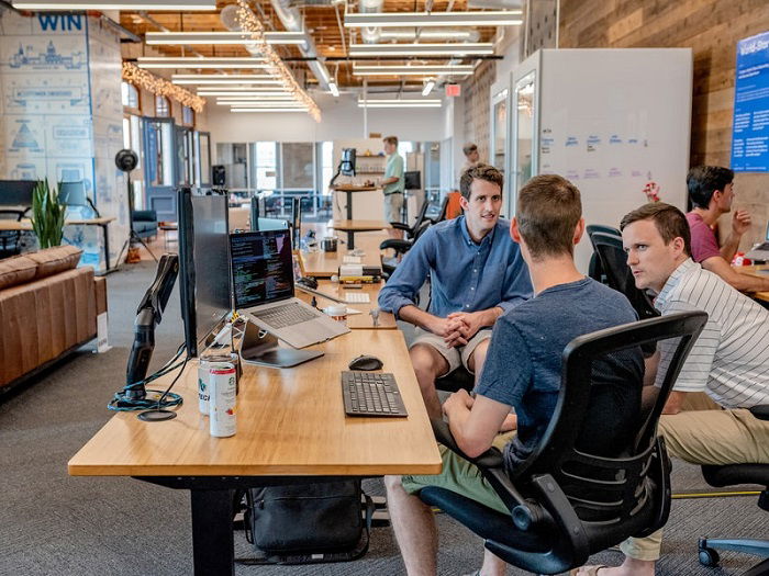 men having a meeting in an open office space