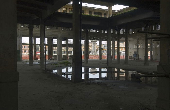 light reflects off of a puddle in an abandoned building