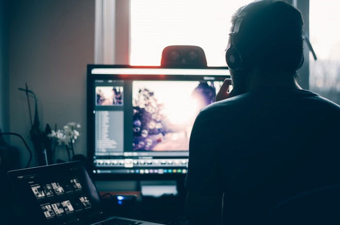 a photographer touching up their shots at a desk