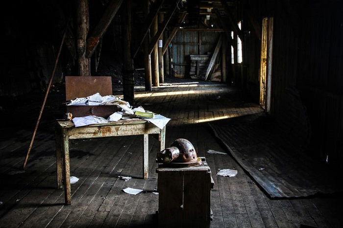 a desk full of old papers in an abandoned building