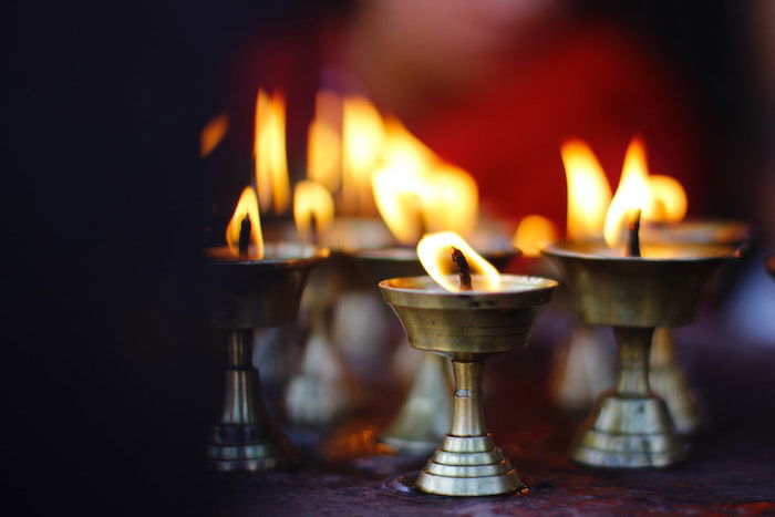 A grouping of lit votive candles