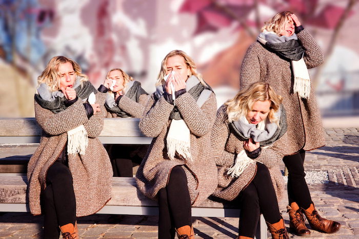 multiple exposure effect to show of one person with a cold in many positions outdoors