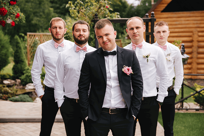 groom and groomsmen photo standing in arrow formation