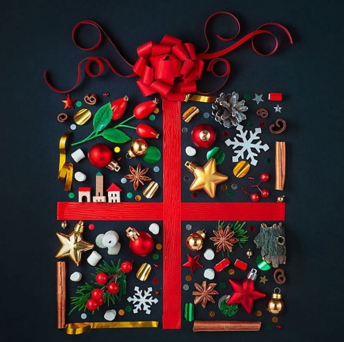 Christmas flat lay of a present made up of colorful ornaments and winter objects