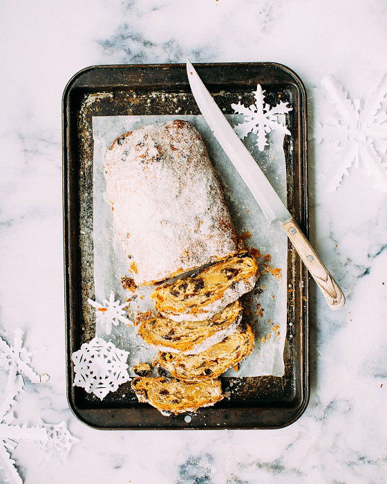 Christmas flay lay of fruit loaf cut and dusted with icing sugar