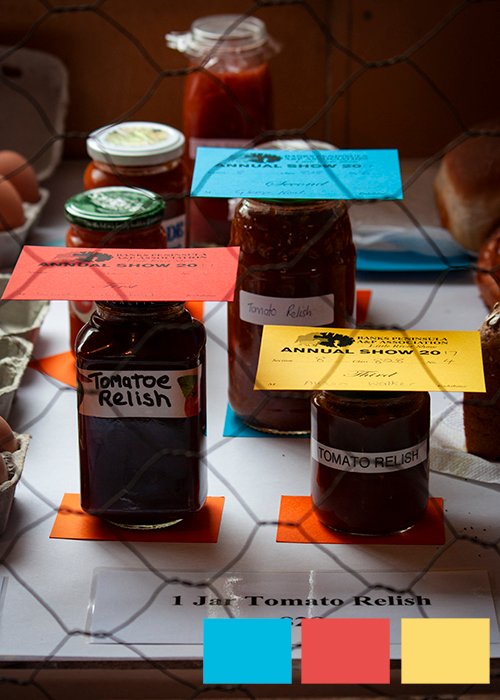 jars of relish aligned with colored annual show passes to show a triadic color scheme in photography