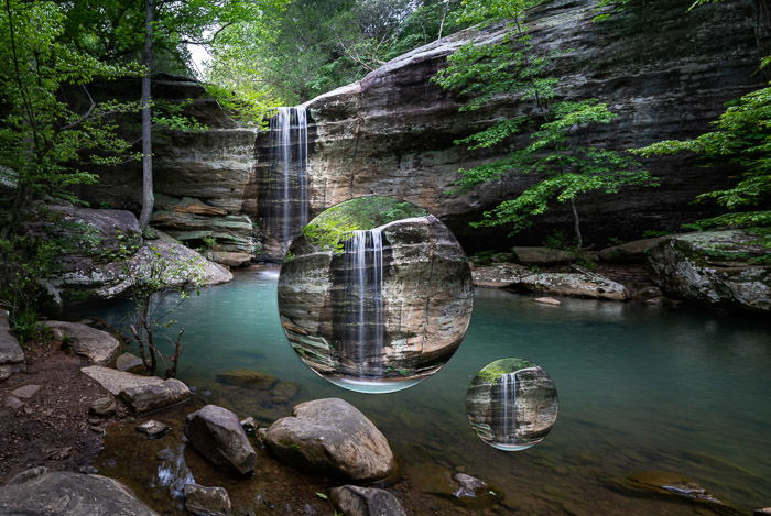 Reflecting balls in a waterfall landscape using the Bloat Liquify tool in Photoshop