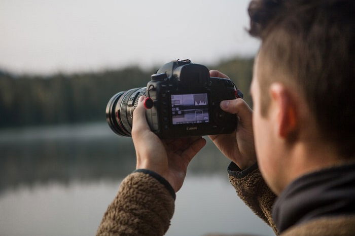 a photo taken from behind a photographer taking his own photo