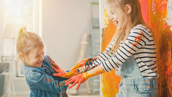 Two Girls Playing With Paint as sister photoshoot idea