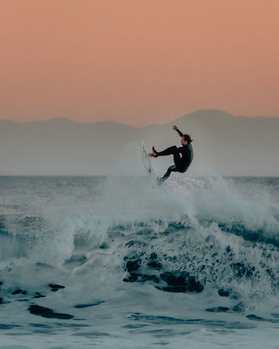 a surfer in the waves photographed