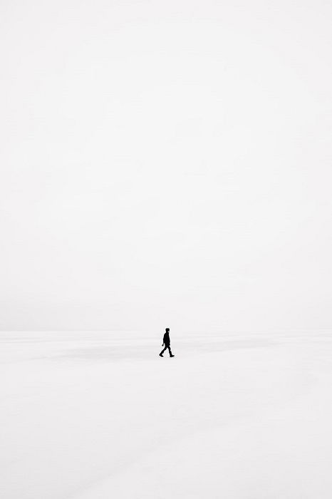 Surreal Photography example of a man walks on pure white landscape