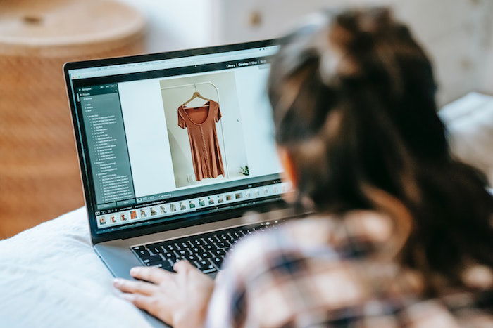 an orf file of a woman looking at dresses on a macbook