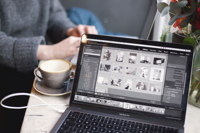 a desaturated image of a macbook pro with lightroom open