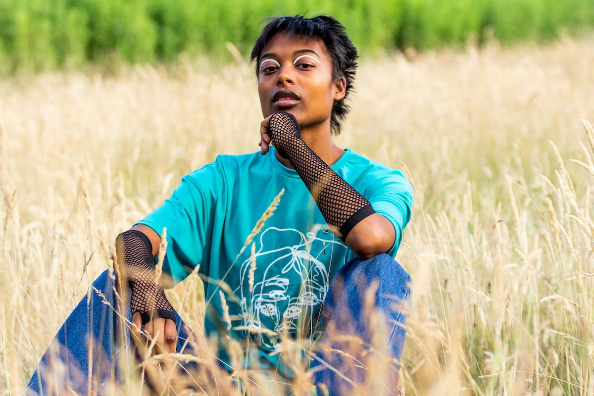 Portrait of a non-binary person in a field of tall grass