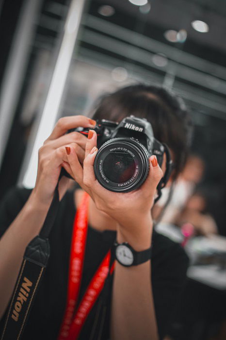 Woman using a Nikon DSLR