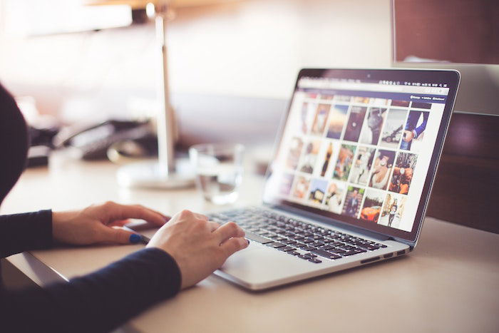 Person organizing photos on a laptop computer