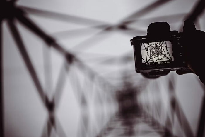 Camera taking picture of electricity pylon