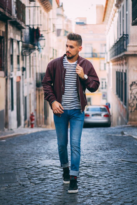 Model walking down a cobblestone street