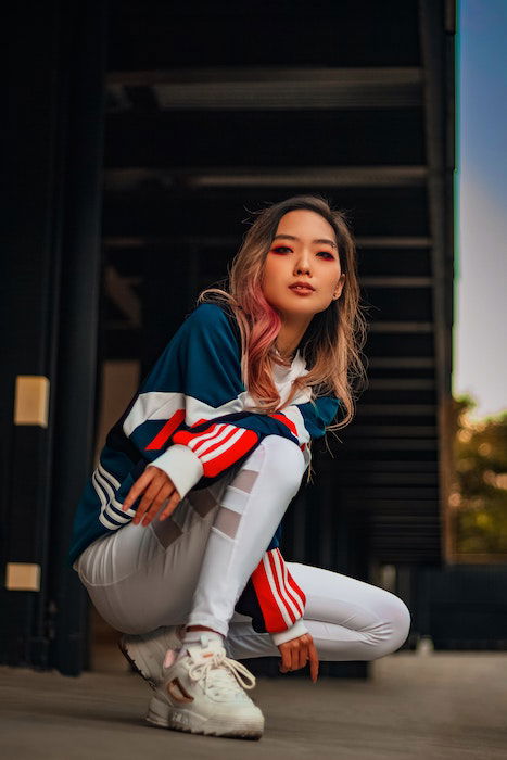 Woman squatting in sportswear as an idea for model poses