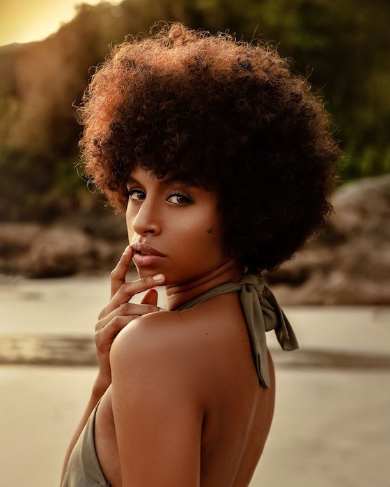 Woman on a beach looking over shoulder as an example of model poses