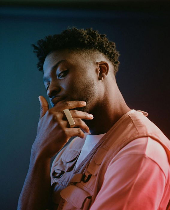 Studio portrait of man in pink hoodie