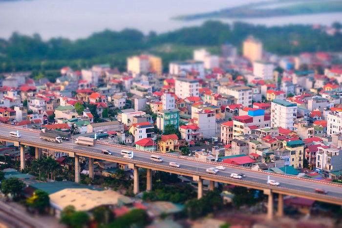 A miniature city with cars driving along an elevated highway