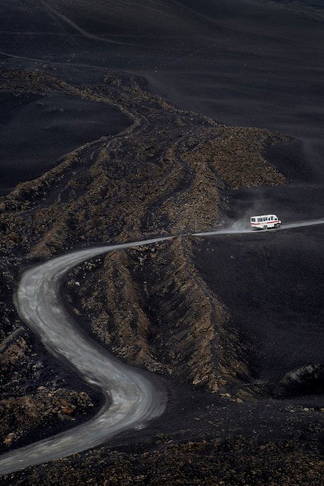 A shot of a truck on a mountain road. the truck looks like a miniature model