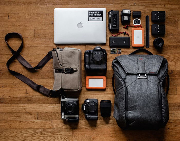 Photography equipment laid out on a wooden floor