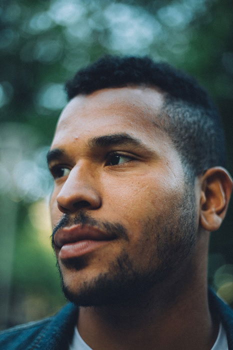 Close portrait of a man with soft bokeh background that creates emphasis