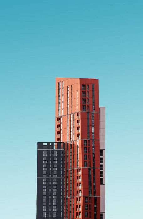 Tall narrow building against a clear blue, as an example for architecture photography