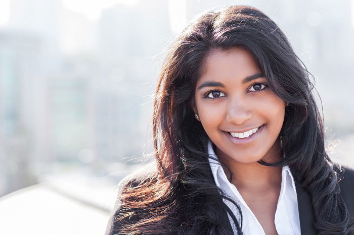 Headshot of woman in suit outside for a headshot photography shoot