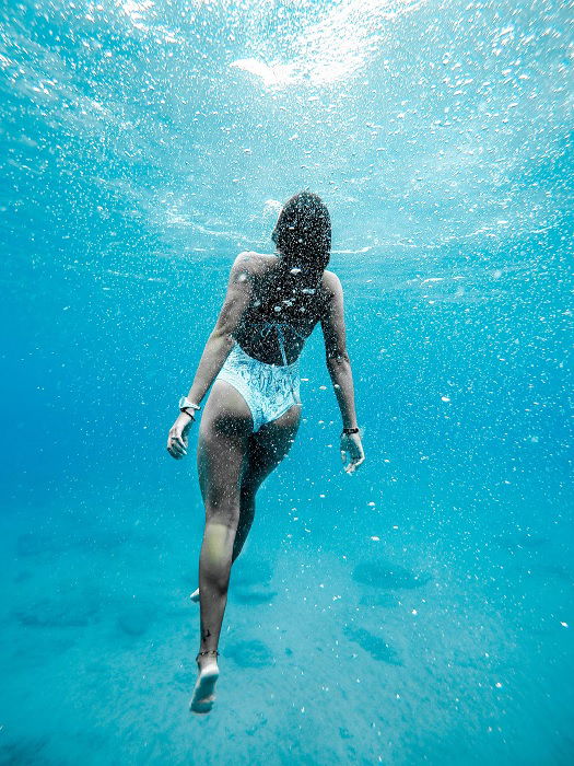 Underwater photo of a female swimmer rising to the surface