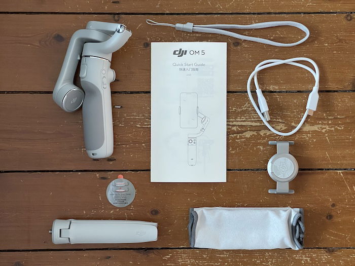 DJI OM 5 smartphone gimbal and accessories flatlay