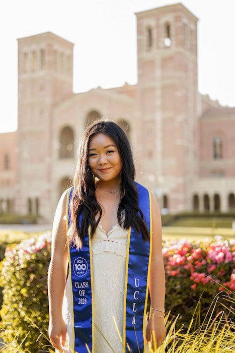 Senior high-school graduate posing on a school campus