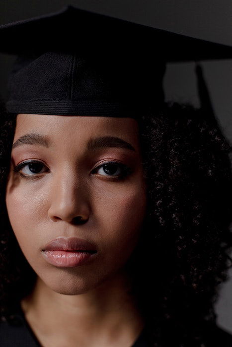 Close up headshot of a senior high-school graduate with a somber look