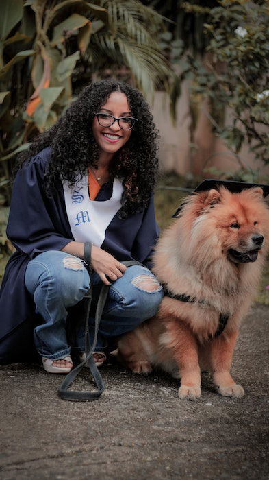 A woman posing with a dog