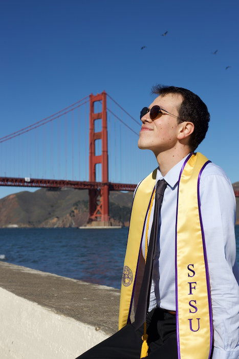 Student sitting with the Golden Gate Bridge in the background