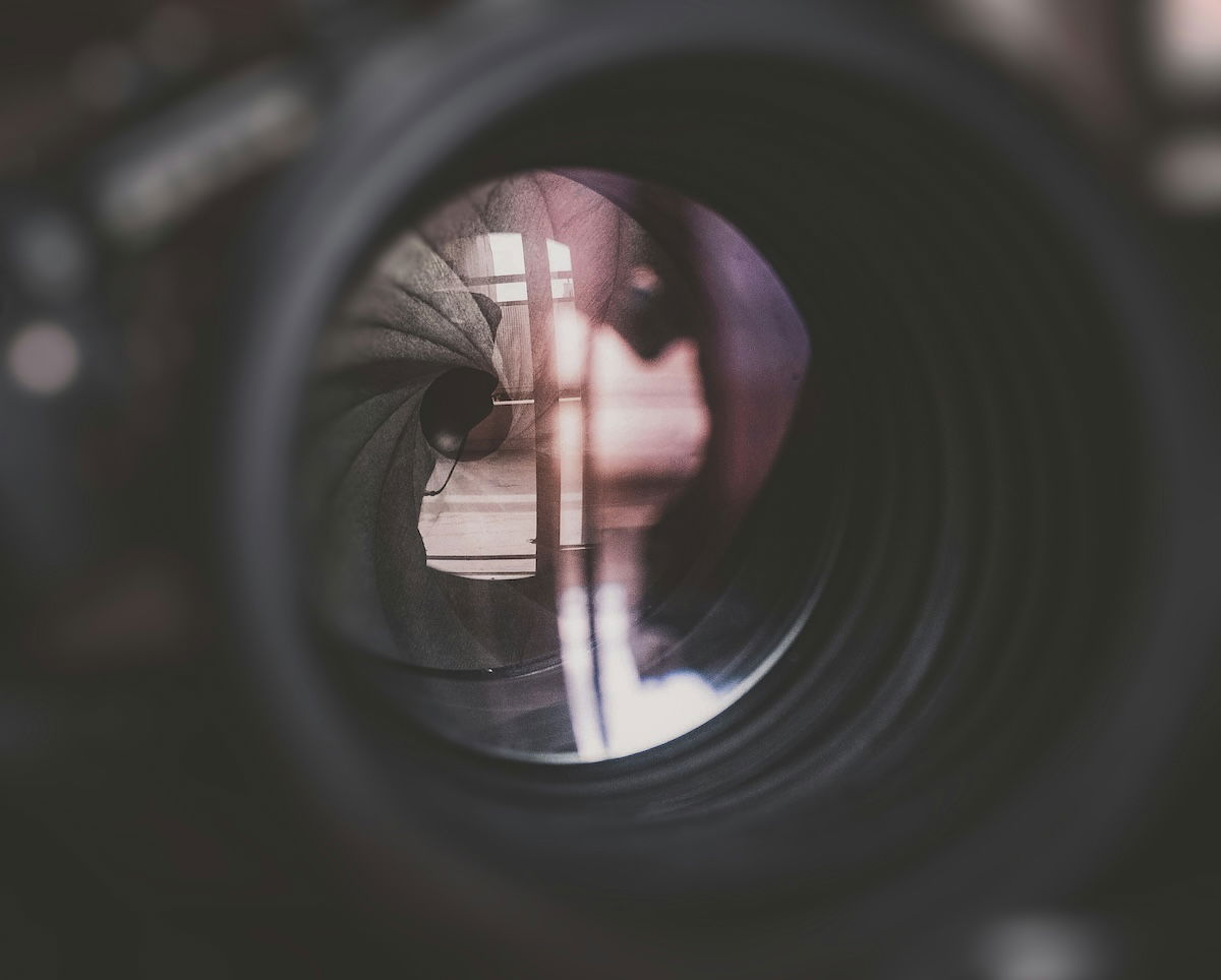 Close-up of a camera lens aperture and reflection