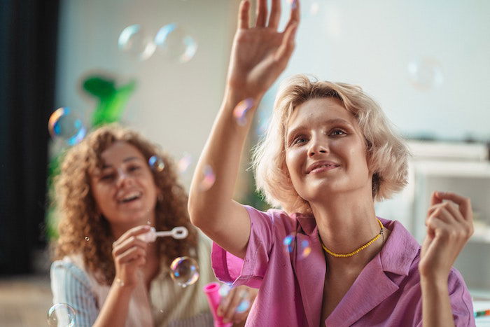 girls blowing and playing with bubbles 