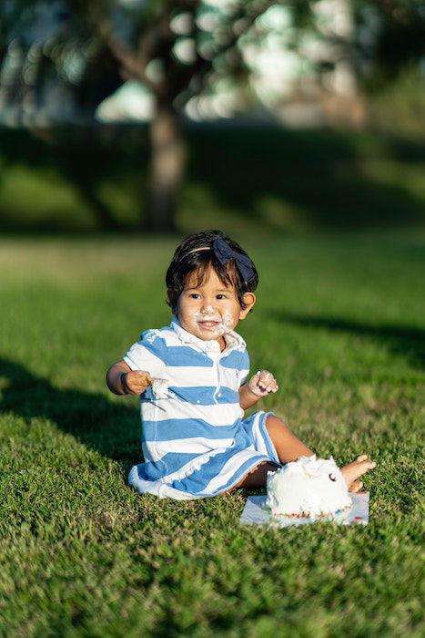 kid with cake on their face